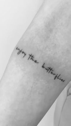 a person with a tattoo on their arm that says, enjoy the little things in life