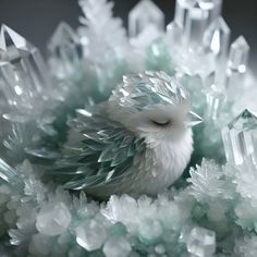 a small white bird sitting on top of crystals