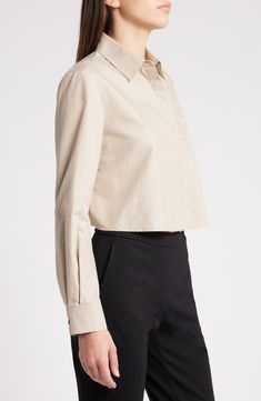 A cropped silhouette balanced by a slightly boxy fit enhances the breezy look of this button-up shirt cut from smooth poplin. Hidden-button placket Point collar Long sleeves with button cuffs Chest patch pocket 53% cotton, 47% polyester Dry clean Imported Classic Cropped Button-up Shirt With Button Cuffs, Chic Cropped Office Shirt, Elegant Cropped Cotton Shirt, Chic Button-up Cropped Workwear Shirt, Modern Collared Cropped Shirt For Work, Chic Button-up Cropped Shirt For Work, Classic Cropped Shirt For Office, Elegant Button-up Cropped Shirt For Work, Chic Collared Cropped Shirt For Work