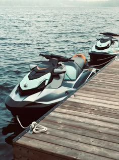 two jet skis are parked on the dock