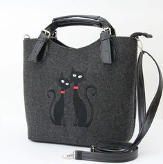 a handbag with two black cats on it