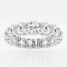 a white gold ring with three rows of round cut diamonds on the side and sides