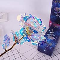 a glass flower on a twig next to two boxes