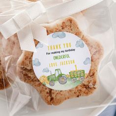 some cookies are wrapped in plastic and have a thank you tag on them for someone's birthday