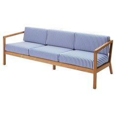 a blue and white striped couch sitting on top of a wooden frame