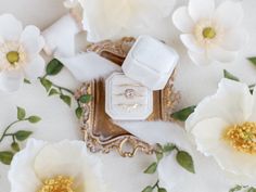 wedding rings and flowers on a white background