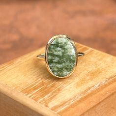 Estate/ vintage 10KT yellow gold oval, genuine green jade ring. Beautiful, earthy green jade set on a low profile setting. Size 6 Weight: 2.60 grams Band width: 2mm Jade measures: 14mm x 10mm Stamped 10KT Excellent estate condition Classic Green Jewelry With Large Stone, Elegant Untreated Oval Emerald Ring, Green Oval Gemstone Rings, Oval Green Jewelry With Polished Finish, Oval Jade Jewelry With Natural Stones, Classic Green Oval Jewelry, Green Rings With Large Oval Cabochon Stone, Green Oval Cabochon Ring With Large Stone, Green Oval Ring With Large Stone