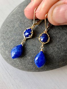 Lapis Lazuli Earrings, Navy Blue Dangle Earrings, September Birthstone, Blue Lapis Earrings in Gold, Earrings for women, Gift for her These Indigo Blue Drop Earrings feature lapis lazuli hexagonal stones framed in 14k gold filled and suspended from them are lapis lazuli teardrops, wire wrapped in 14k Gold Filled. The Earrings are suspended from gold filled lever back ear wires. These are ideal for a night out, they are a great choice for causal wear and they will provide a beautiful pop of color Blue Adjustable Long Drop Jewelry, Blue Nickel-free Linear Earrings For Gift, Blue Lapis Lazuli Drop Earrings, Blue Teardrop Lapis Lazuli Earrings, Blue Lapis Lazuli Teardrop Earrings, Blue Gemstone Crystal Drop Earrings, Blue Gemstone Dangle Earrings, Blue Linear Earrings With Ear Wire For Gift, Blue Teardrop Jewelry With Matching Earrings