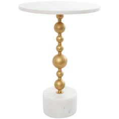 a white and gold table with three balls on the top, sitting on a marble base