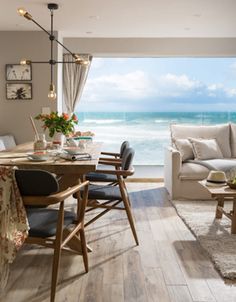 a living room filled with furniture and an ocean view