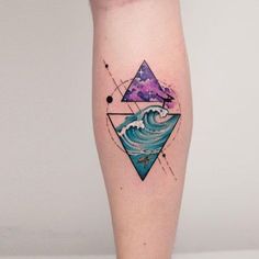 a tattoo on the leg of a person with an ocean wave and stars in the sky