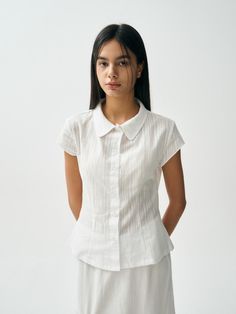 This product features the Scent Shirt, a sophisticated and versatile top perfect for both casual and formal settings. The shirt offers a tailored fit with elegant vertical stripes, adding a touch of class to any outfit. It combines comfort with a refined design, making it a valuable addition to any wardrobe. - This Scent Shirt is crafted from high-quality, breathable fabric, ensuring comfort throughout the day.- The shirt features a button-down front with a classic collar, providing a timeless and polished look.- It has vertical stripes that elongate the silhouette, adding a subtle yet stylish detail.- The short sleeves and tailored fit make it versatile for various occasions, easily pairing with skirts, trousers, or jeans for a chic and elegant appearance. Chic And Elegant, Vertical Stripes, Polished Look, Shirt White, Breathable Fabric, Product Features, The Day, Short Sleeves, Trousers