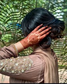 a woman with her hands on her face and arm covered in hendi tattoos,