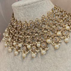 This beautiful Antique Gold necklace set which can be adjusted to be worn flat or as a low choker. Set is scattered with dazzling clear zircon crystals and tiny pearl bead detailing. Set includes jhumka earring and tikka.  Necklace 3 inch length (Adjustable string) Earrings approx 2.25 inch length x 1 inch width  Tikka pendant 1.5 inch length x 1.5 inch width Perfect for a glam bridal look. Ready to ship! Luxury Gold-plated Kundan Necklace For Diwali, Hand-set Crystal Kundan Necklace For Wedding, Festive Multicolor Gold-plated Bridal Necklace, Elegant Kundan Dual-tone Bridal Necklace, Festive Dual-tone Kundan Bridal Necklace, String Earrings, Clear Crystal Necklace, Necklace Set Indian, Gold Necklace Set