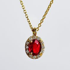 MELIGreece's timeless necklace in 18 carats yellow gold with a beautiful oval ruby weight 0.23 cts. accented with round brilliant cut diamonds, weight: 0.05 cts. color: G, Clarity: VS. Rubies, the birthstone of July, are considered the king of gems and represent love, health and wisdom. It was believed wearing a fine red Ruby bestowed good fortune on its owner. Dimensions of the ruby: 3.0 *4.0 mm. A mineral ruby with stunning deep red color surrounded by white diamonds pendant set in a 18k yello Exquisite Red Necklace For Gift, Elegant Ruby Pendant Birthstone Necklace, Red Oval Cubic Zirconia Necklace, Exquisite Red Pendant Necklace, Elegant Ruby Oval Pendant Necklace, Elegant Ruby Necklace With Oval Pendant, Red Diamond Pendant Necklace, Exquisite Ruby Pendant Necklace, Exquisite Oval Diamond Necklace Gift