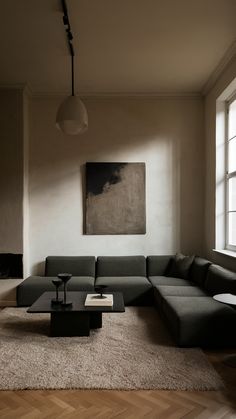 a living room with a couch, coffee table and large painting hanging on the wall