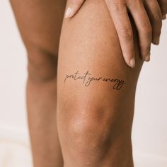 a woman's leg with the words protect your energy written on it in cursive writing