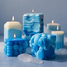 blue candles are sitting on some ice