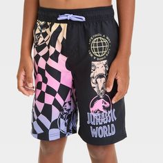 Elevate your kid's swimwear wardrobe with these Jurassic World Shapes Printed Swim Shorts in black. Made of 100% polyester, these regular-rise shorts showcase "Jurassic World" logos and shapes along with the text "Jurassic World." Designed in an at-knee length, these shorts feature a full elastic waistband for a snug, stay-put fit. Plus, the UPF 50+ rating offers extra sun protection. Casual Black Bottoms For Pool, Black Nylon Shorts For Beach Season, Black Beachwear Shorts For Pool, Casual Black Swim Trunks For Pool, Moisture-wicking Shorts For Summer Play, Black Nylon Shorts For Pool, Black Shorts With Elastic Waistband For Poolside, Black Poolside Shorts With Elastic Waistband, Black Summer School Bottoms