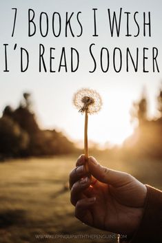 a person holding a dandelion with the words 7 books i wish i'd read