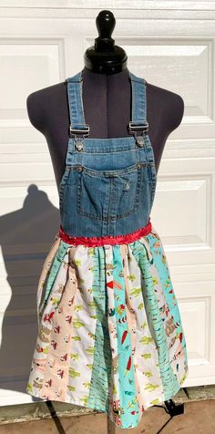 a mannequin wearing an apron made out of old denims and other fabric