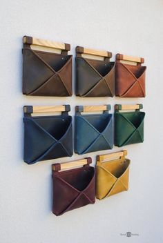 six leather envelopes hanging on the wall