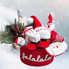 a basket filled with santa claus and other christmas decorations on top of snow covered ground