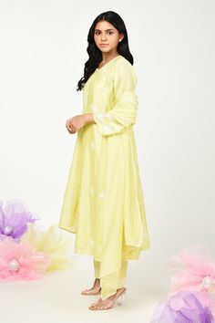 Yellow chanderi kurta with thread embroidery in floral placement pattern. Paired with cotton pant, inner and dupatta.
Components: 4
Pattern: Embroidery
Type Of Work: Thread, floral
Neckline: Round
Sleeve Type: Three quarter
Fabric: Chanderi
Color: Yellow
Other Details: 
Front button detailing
Lace embellished border
Embroidery on pant hem
Note: Potli shown in the image is not for sale
Occasion: Puja - Aza Fashions Pista Green Straight Kurta Anarkali Set For Spring, Chanderi Lawn Suit With Floral Embroidery For Navratri, Spring Churidar With Straight Kurta And Dupatta, Navratri Chanderi Lawn Suit With Floral Embroidery, Spring Mulmul Anarkali Set, Spring Festive Anarkali Kurta, Spring Straight Kurta Anarkali Set With Floral Embroidery, Pista Green Cotton Silk Sets With Floral Embroidery, Spring Palazzo Set With Zari Work And Straight Kurta