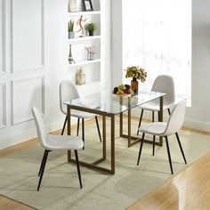 a glass dining table with white chairs and shelves on the wall in front of it