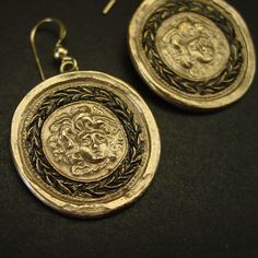 "Handmade gorgon Medusa cameo museum earrings, Gorgone Meduse, perfect gift for fans of Percy Jackson. This cameo represents the head of Medusa placed on a shield by Theseus and given to Athena to use during battle for protection. It was then later used by knights on their shields and the front of castles for protection. - Handmade cameo reproduction. - Solid yellow bronze cameo, also called jeweler gold bronze - 14K gold filled ear wire. - Gold filled has 100 times more gold than plated thus do Ceremonial Gold Earrings With Oxidized Finish, Symbolic Bronze Drop Earrings, Handmade Bronze Ceremonial Earrings, Nickel Free Brass Medallion Earrings, Nickel-free Brass Medallion Earrings, Handmade Bronze Earrings For Ceremonial Occasion, Brass Medallion Earrings For Pierced Ears, Brass Medallion Earrings As A Gift, Symbolic Earrings With Oxidized Finish For Gift