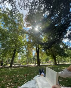 someone is reading a book in the park