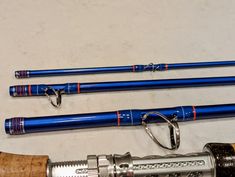 three different types of fishing rods on a table