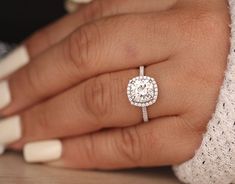 a woman's hand with a diamond ring on it