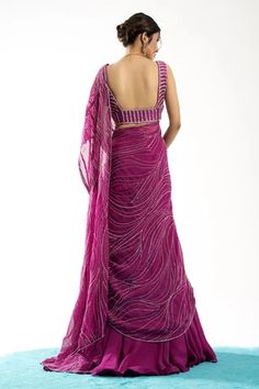 Purple organza pre-draped lehenga saree with twisted linear embroidery details and front pleats. Comes with embroidered blouse.
Component: 2
Pattern: Embroidery
Type Of Work: Linear
Neckline: Sweetheart
Sleeve Type: Sleeveless
Fabric: Blouse: Tussar, Saree: Organza
Color: Purple
Other Details: 
Front pleat detailing
Occasion: Wedding - Aza Fashions Pre-draped Georgette Dress With Zari Work, Pre-draped Saree Dress With Zari Work, Pre-draped Georgette Lehenga For Designer Wear, Fitted Draped Wedding Lehenga, Fitted Draped Gown With Sheer Dupatta, Festive Pre-draped Dress With Dupatta, Draped Art Silk Lehenga With Dupatta, Fitted Draped Lehenga With Cutdana, Wedding Lehenga With Zari Work And Draped Shape