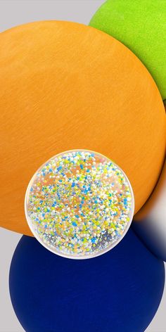 an orange chair with sprinkles on it next to a white and blue table