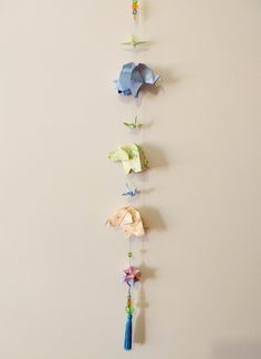 a group of paper birds hanging from the side of a wall