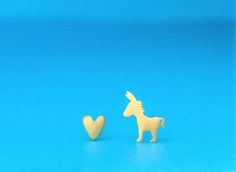 Tiny solid gold donkey and heart earrings, horse love stud with solid gold posts and ear nuts.  This listing is for one pair, one goat earring and on heart earring. These cute earrings are perfect for any age and make for a great gift.The tiny donkey measures 10mm / 0.4 inches, the heart 5 mm. Available in 9k and 14k yellow gold, 14k white gold and 9k and 18k rose gold.All earrings are made to order.Shipping is by air mail with tracking, DHL express shipping is available at check out.PLEASE NOTE Mismatched Jewelry, Dinosaur Necklace, Dragon Earrings, Heart Earring, Teen Birthday, Tiny Studs, Solid Gold Earrings, Mom Jewelry, Horse Love