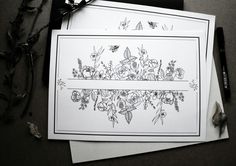 two cards with flowers and butterflies on them next to a pen, scissors and paper