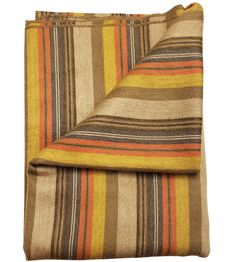 an orange, brown and yellow striped blanket folded on top of each other with a white background