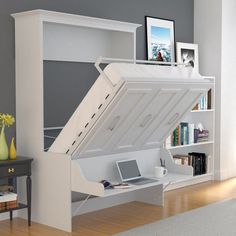 a bed with a desk underneath it in a room next to a book shelf and bookshelf