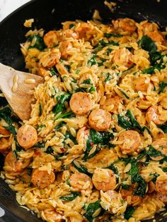 pasta with sausage and spinach in a skillet