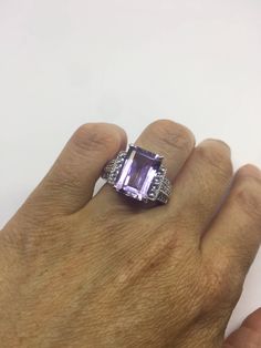 Unusual genuine Amethyst ring set with white sapphire on the sides. Very unusual. Sterling Filigree Setting Handmade size 7.5 can be re sized for you. Sterling Silver is rhodium finished to prevent tarnish All rings are shipped in a nice gift box. Check out our over a THOUSAND great reviews Engraving is $4 per letter and is not always perfect depending on the piece. It can take a few days if the jeweler is busy. This is payable to Paypal Judithsltd@gmail.com White Gold Sterling Silver Amethyst Ring With Diamond Accents, Sterling Silver Amethyst Ring With Diamond Accents For Anniversary, Silver Amethyst Rings With Diamond Accents, Amethyst Ring With Diamond Accents For Anniversary, Silver Emerald Cut Gemstones With Accent Stones, Octagon Silver Amethyst Ring For Formal Occasions, Silver Octagon Amethyst Ring Gift, Silver Amethyst Ring With Emerald Cut Accent Stones, Amethyst Jewelry With Accent Stones In Octagon Shape