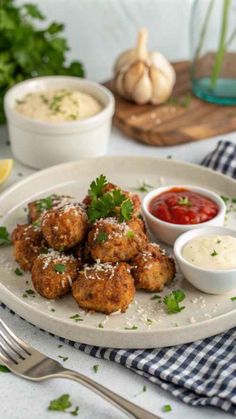 a white plate topped with meatballs covered in parmesan cheese and garnish