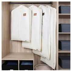 an organized closet with hanging clothes and storage bins