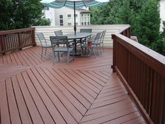 a deck with chairs and an umbrella on it