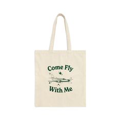 "Our vintage-inspired \"Come Fly With Me\" Airplane Canvas Tote Bag was made for the farmer's market, or your favorite shop around town. This cool and retro-inspired tote is perfect for the stylish jet setter with a love for all things aviation, or pilot! Our tote bag features a retro-style hand-drawn airplane with the groovy saying \"Come Fly With Me\" on a 100% cotton canvas market bag. This aircraft canvas tote bag is not only stylish but also durable, making it the ultimate accessory for you Retro Shoulder Bag With Letter Print For Travel, Vintage Bags With Letter Print For Everyday Use, Retro Pouch Bag As Gift, Green Letter Print Bags As Gifts, Retro Everyday Bag With Letter Print, Vintage Everyday Bags With Letter Print, Everyday Vintage Bags With Letter Print, Retro Shoulder Gift Bag, Green Bag With Letter Print For Gift