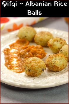 some food is on a white plate with red border around it and the words qfiq - abanan rice balls