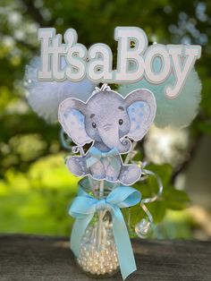 it's a boy card in a vase with an elephant on the top and blue ribbon