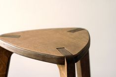 a close up of a wooden chair with curved legs