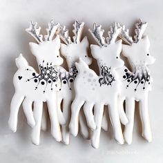 four decorated cookies in the shape of deers